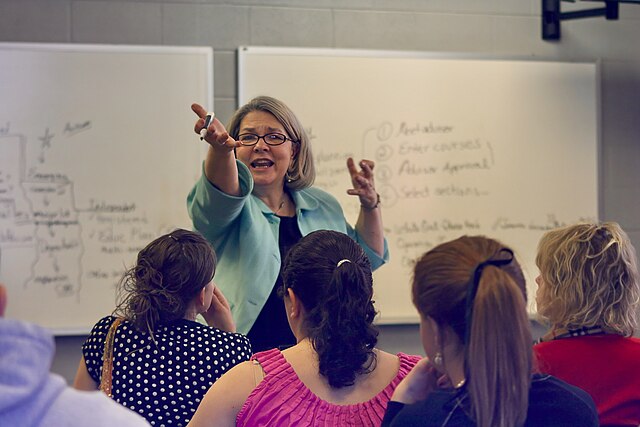 u334-A_college_professor_teaching_in_a_university_classroom_full_of_students_in_Tennessee_United_States_02-1
