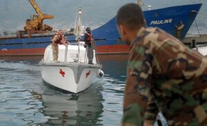 u336-US_Navy_070901-N-4238B-432_Builder_1st_Class_Robert_Mendez_waits_as_a_hospitality_boat_from_Military_Sealift_Command_hospital_ship_USNS_Comfort_T-AH_20_arrives_to_pick_up_crew_members_who_had_gone_ashore_to_set_u