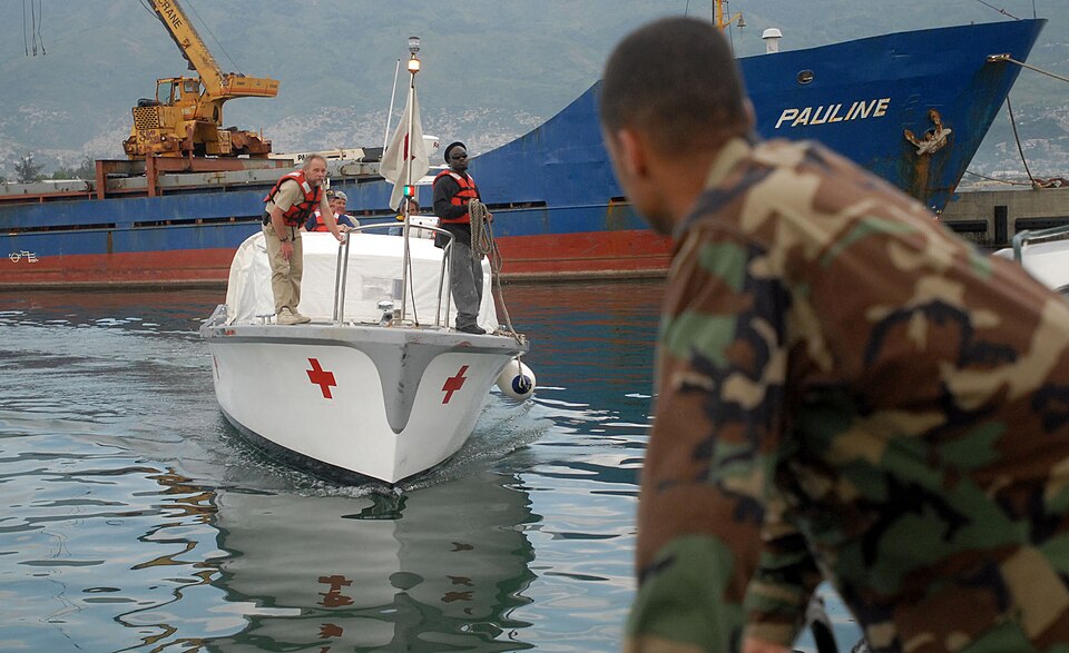 u336-US_Navy_070901-N-4238B-432_Builder_1st_Class_Robert_Mendez_waits_as_a_hospitality_boat_from_Military_Sealift_Command_hospital_ship_USNS_Comfort_T-AH_20_arrives_to_pick_up_crew_members_who_had_gone_ashore_to_set_u